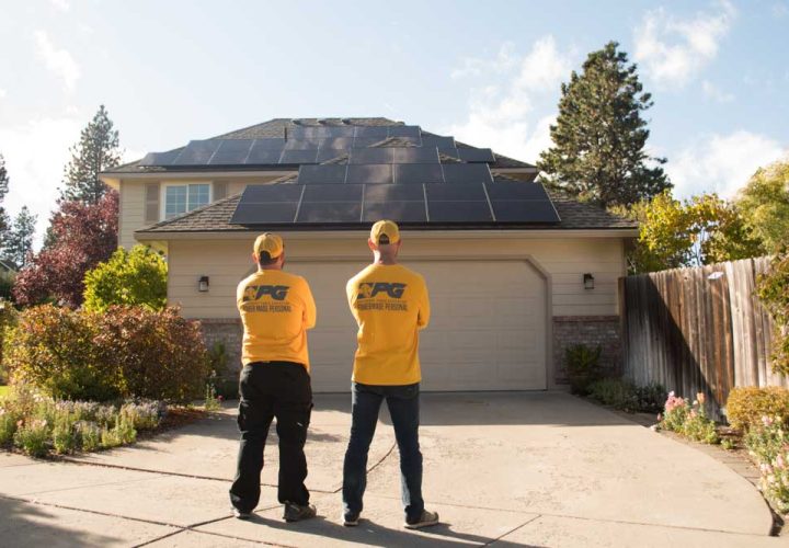 veteran solar contractor standing infront of a house after solar panel installation